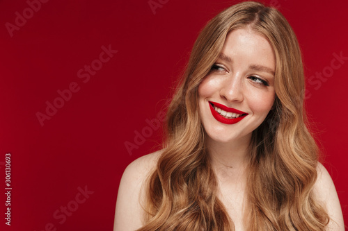 Woman posing isolated over red wall background
