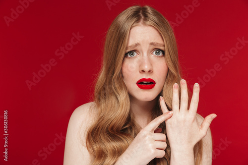 Sad woman without wedding ring on finger.