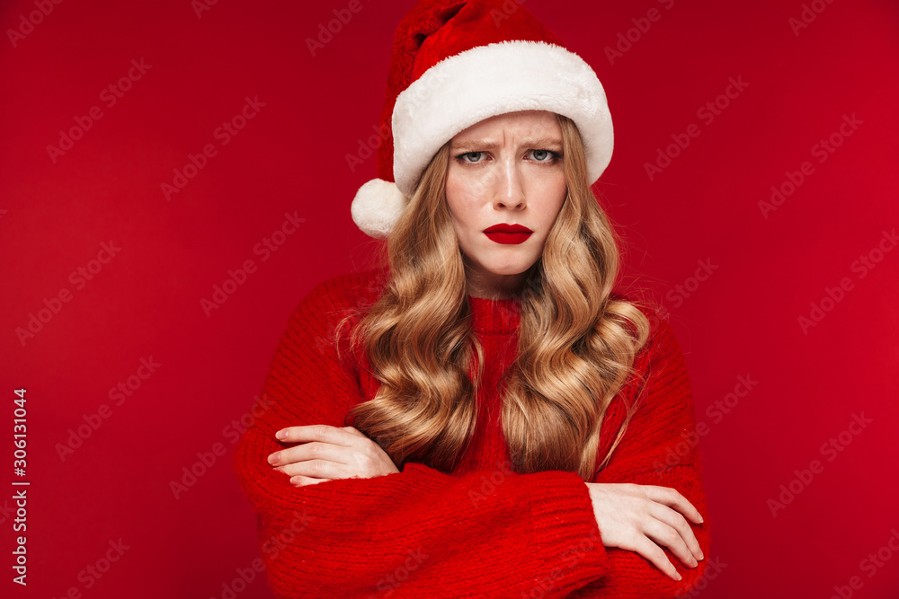 Offended caucasian woman wearing christmas hat.
