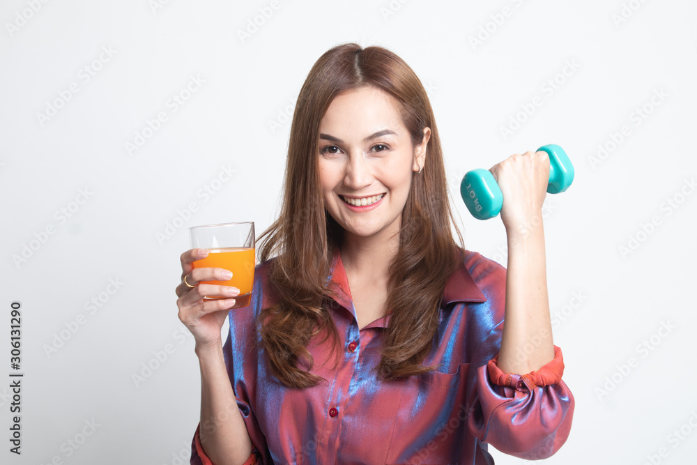 Young Asian woman with dumbbell drink orange juice. Young Asian woman with dumbbell drink orange juice.