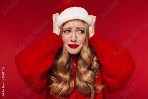 Confused caucasian woman wearing christmas hat.