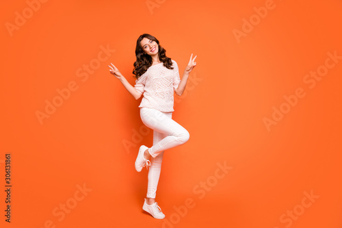 Full length photo of charming girl have summer free time make v-sign enjoy holidays wear good looking outfit isolated over orange color background