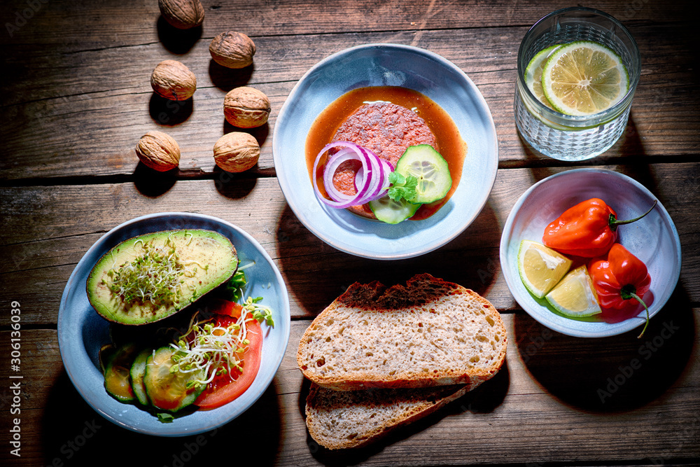 tasty avocado with tomatoes, snake cucumber, red onions, bread, burger, lemonade and chillies