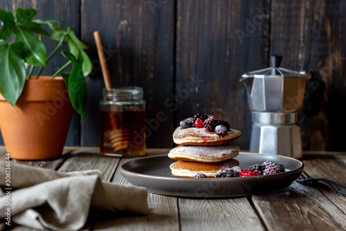 Pancakes with blackberries, raspberries and red currants. American cuisine.