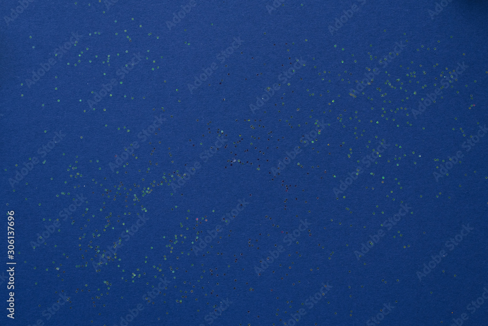 Rich blue background color with sequins to copy space Rich blue background color with sequins to copy space