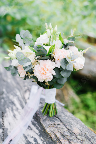 Beautiful delicate wedding bouquet in rustic style with eucalyptus and carnations, eustoms for the bride © Sunshine