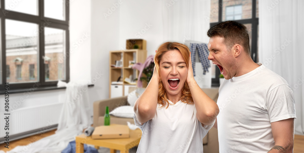 Fototapeta premium relationship difficulties, conflict and violence concept - unhappy couple having argument over messy home room background