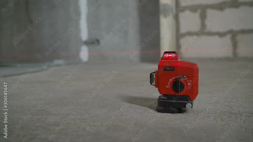 Laser equipment at a construction site/ Construction laser level in a building under construction. Laser equipment at a construction site/ Construction laser level in a building under construction.