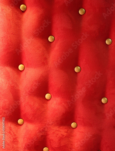 red upholstery background with gold buttons