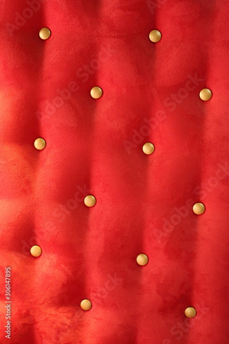 red upholstery background with gold buttons