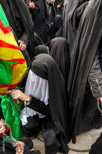 Ashura (asura or asure) ceremony in istanbul. Shiite women mourn for Husayn who killed in Battle of Karbala. Chained woman's hands in Ashura ceremony. photo