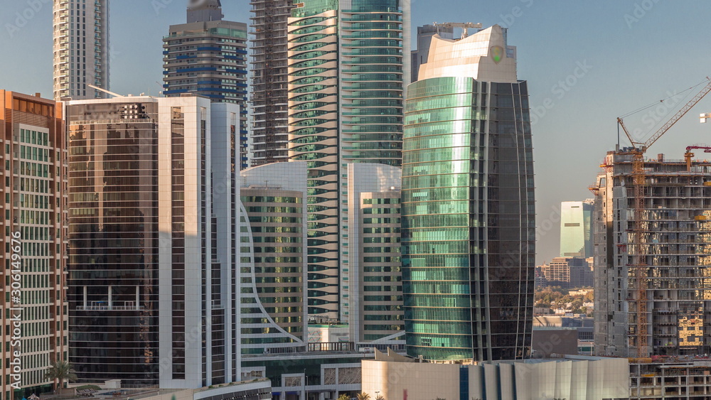 Skyscrapers at sunny day in Dubai with blue sky aerial timelapse