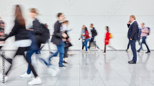 Anonymous lot of business people in hall of trade fair © Robert Kneschke