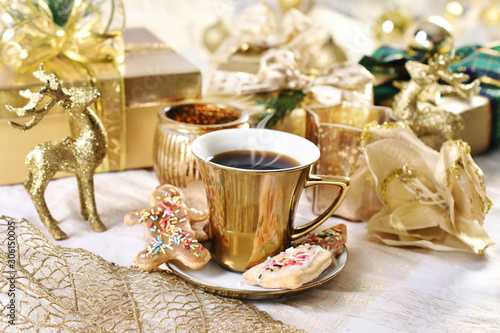 coffee in golden cup and cookies for Christmas time photo