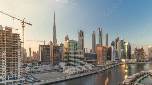 Skyscrapers near canal in Dubai with blue sky aerial timelapse © neiezhmakov