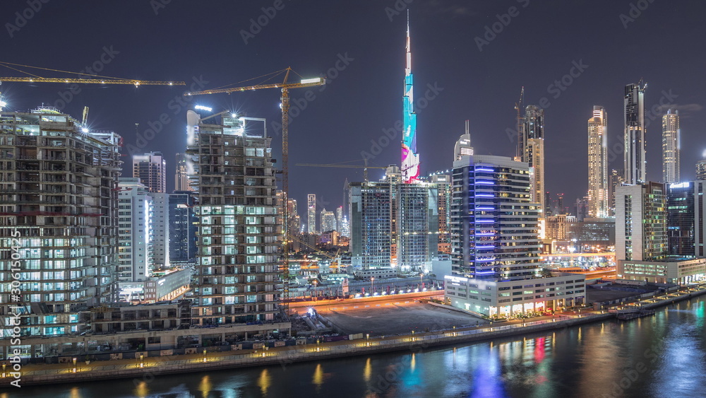Naklejka premium The rhythm of the city of Dubai near canal aerial timelapse