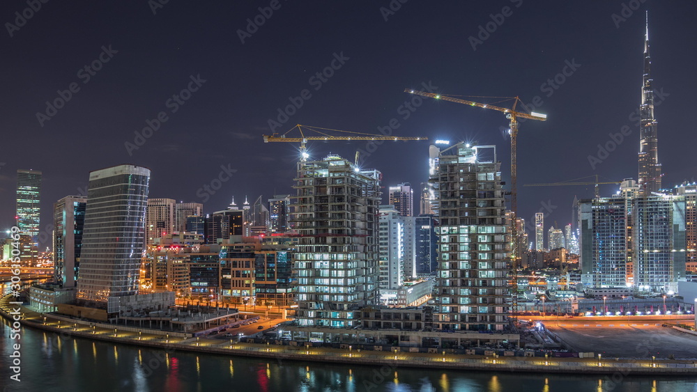 Naklejka premium The rhythm of the city of Dubai near canal aerial timelapse