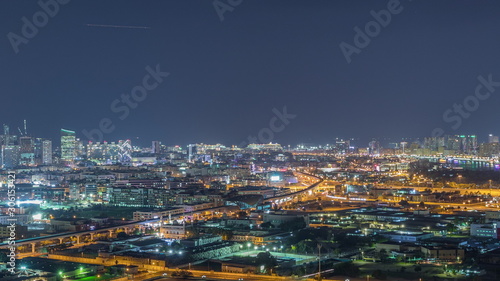 The rhythm of the city at night with illuminated road in Dubai near canal aerial timelapse
