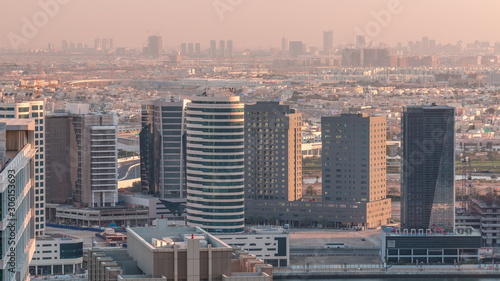 Dubai's business bay towers at evening aerial timelapse.