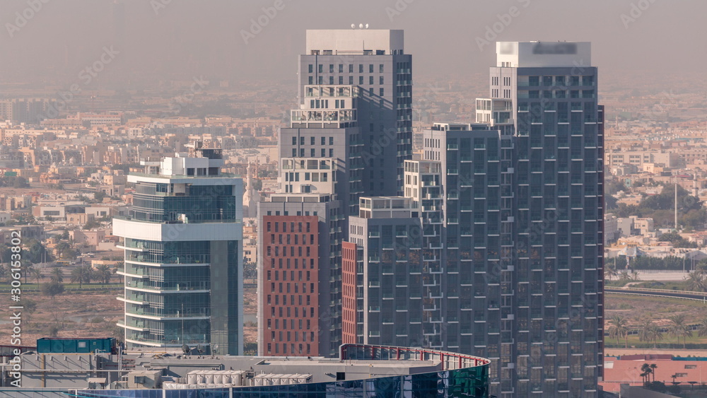 Obraz premium Dubai's business bay towers at morning aerial timelapse.