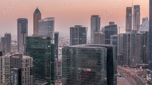 Dubai s business bay towers at evening aerial day to night timelapse.