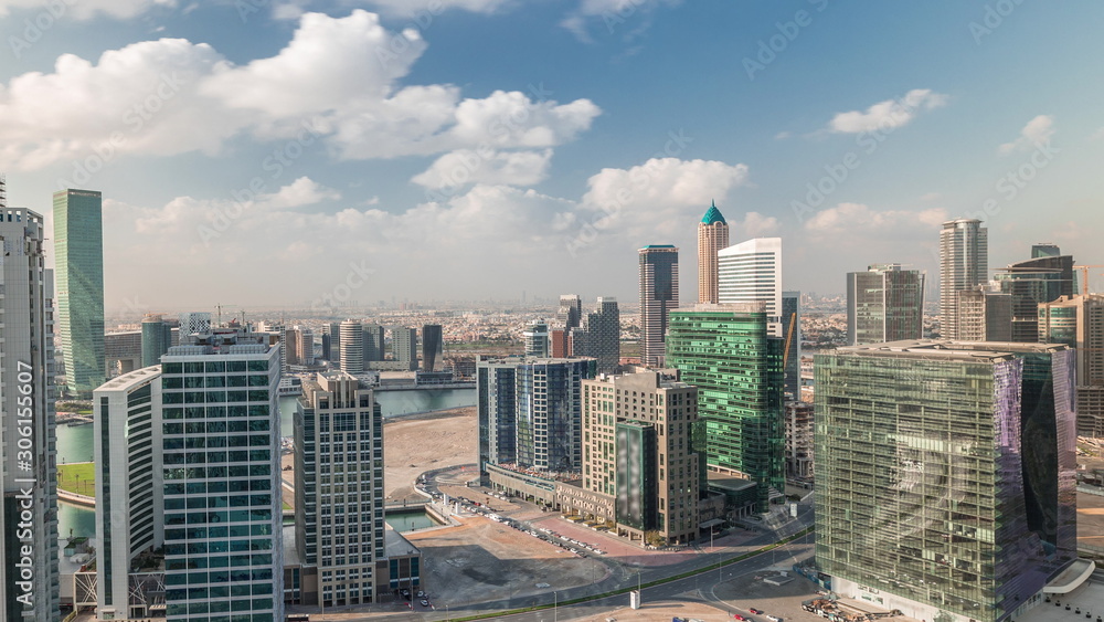 Fototapeta premium Dubai's business bay towers at morning aerial timelapse.