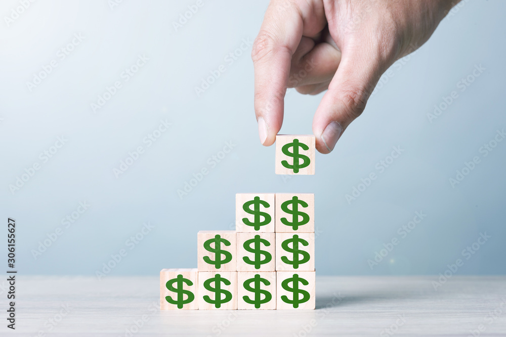 Wood block cubic stacking step up with green Dollar Sign Blue Tone. Business growth success process. Business Concept. Up Trend.