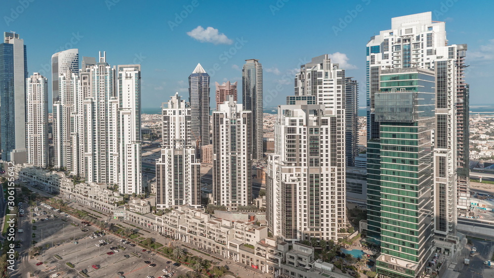 Fototapeta premium Modern residential and office complex with many towers aerial timelapse at Business Bay, Dubai, UAE.
