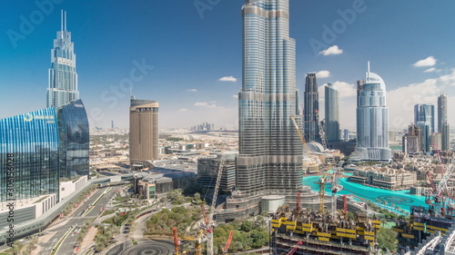Panoramic skyline view of Dubai downtown with mall, fountains and skyscrapers aerial timelapse
