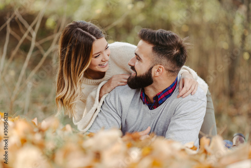 Smiling couple relaxing together outdoors and enjoying in autumn day