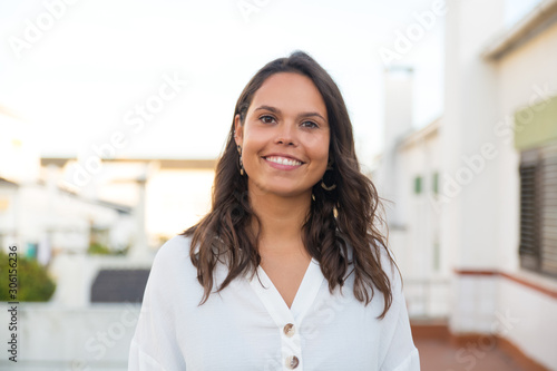 Fotografía Happy Latin woman posing on apartment balcony or terrace