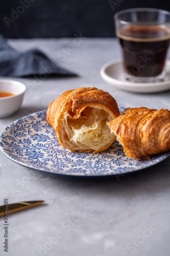 Breakfast with croissant and black coffee