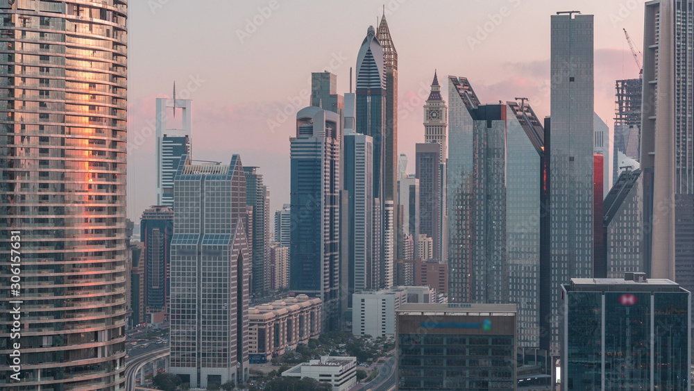 Aerial view of new skyscrapers and tall buildings in Dubai night to day timelapse