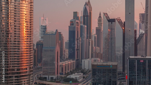 Dubai International Financial Centre district with modern skyscrapers timelapse at sunrise
