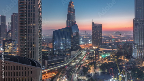 Panoramic skyline view of Dubai downtown before sunrise with mall, fountains and skyscrapers aerial night to day timelapse © neiezhmakov