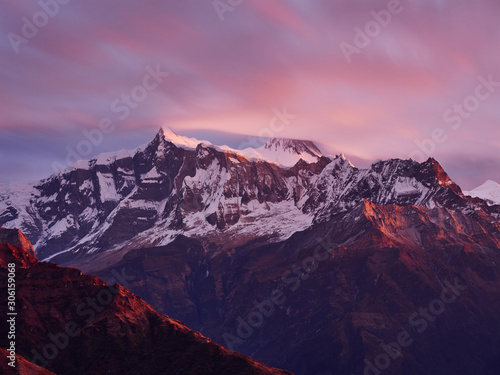 Sunrise overlooking the majestic Himalayan peaks - Annapurna IV and Annapurna II, covered with clouds illuminated by the sunrise. © Maksim