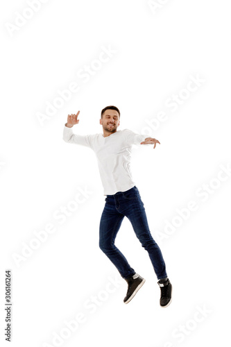 handsome young bearded man jumping. Full length portrait over white background