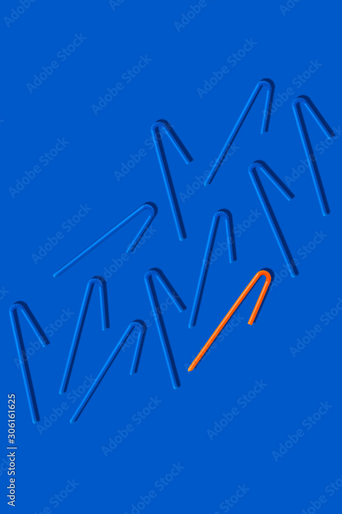 Modern minimal creative concept monochrome pattern of plastic straws on a blue background copy space.Photography collage.Top view,flat lay.Zero waste,save the planet,danger of plastic concept