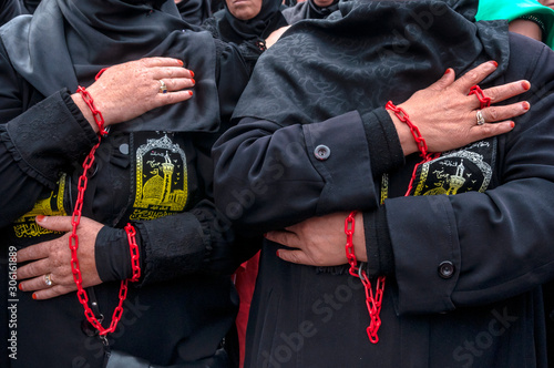 Chained woman's hands in Ashura ceremony. Ashura (asura or asure) ceremony in istanbul. These Shiite women mourn for Husayn who killed in Battle of Karbala. 