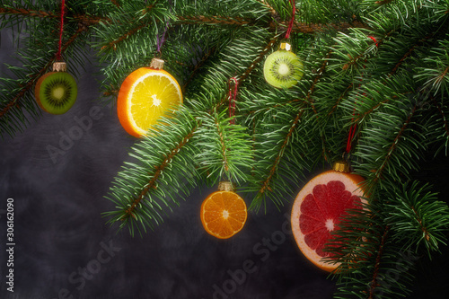 Christmas tree decorated with fruits of kiwi fruit grapefruit, orange, and clementine. Healthy food and nutrition.