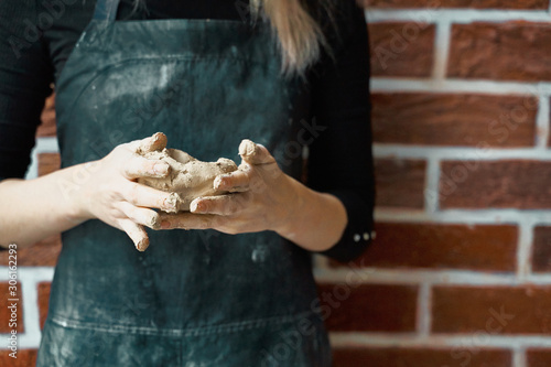 Unrecognisable woman making ceramic bowl in hand. Creative hobby concept. Earn extra money, side hustle, turning hobbies into cash, passion into job, copy space photo