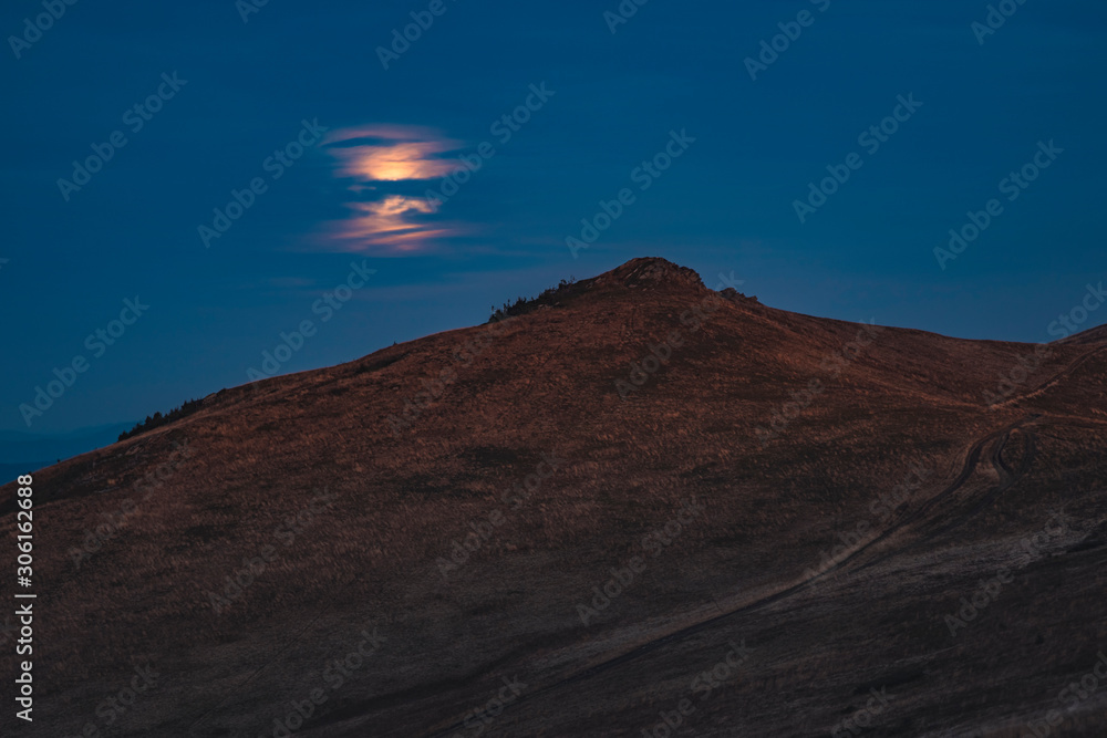 soft focus lonely mountain peak highland scenery landscape mystic photography in twilight slightly foggy weather time with moon behind clouds 