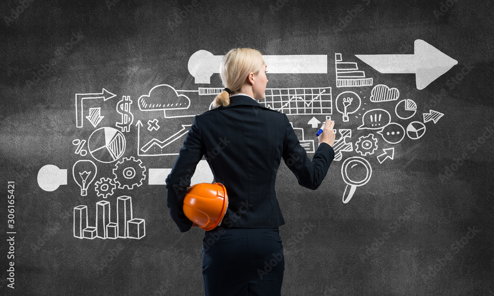 Businesswoman draws various business infographics Businesswoman draws various business infographics