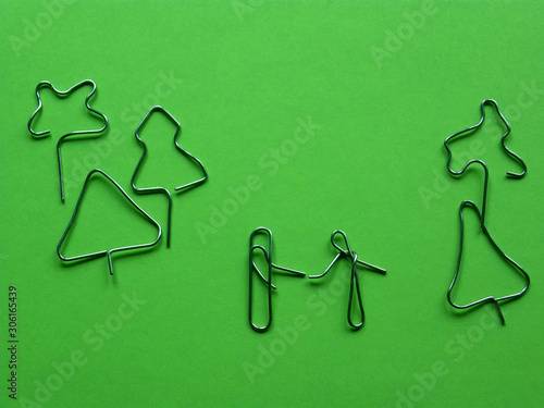 meeting in the park of lovers. installation of paper clips on a green background