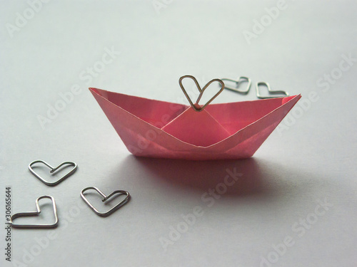paperclip installation on a white background. paper ship - love