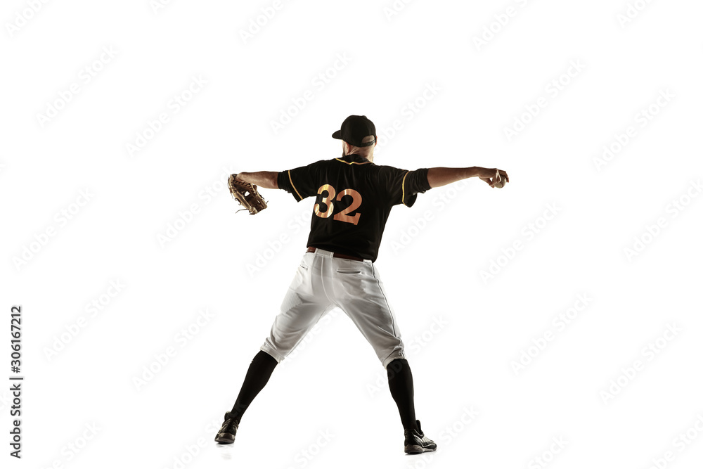 Baseball player, pitcher in a black uniform practicing and training isolated on a white background. Young professional sportsman in action and motion. Healthy lifestyle, sport, movement concept.