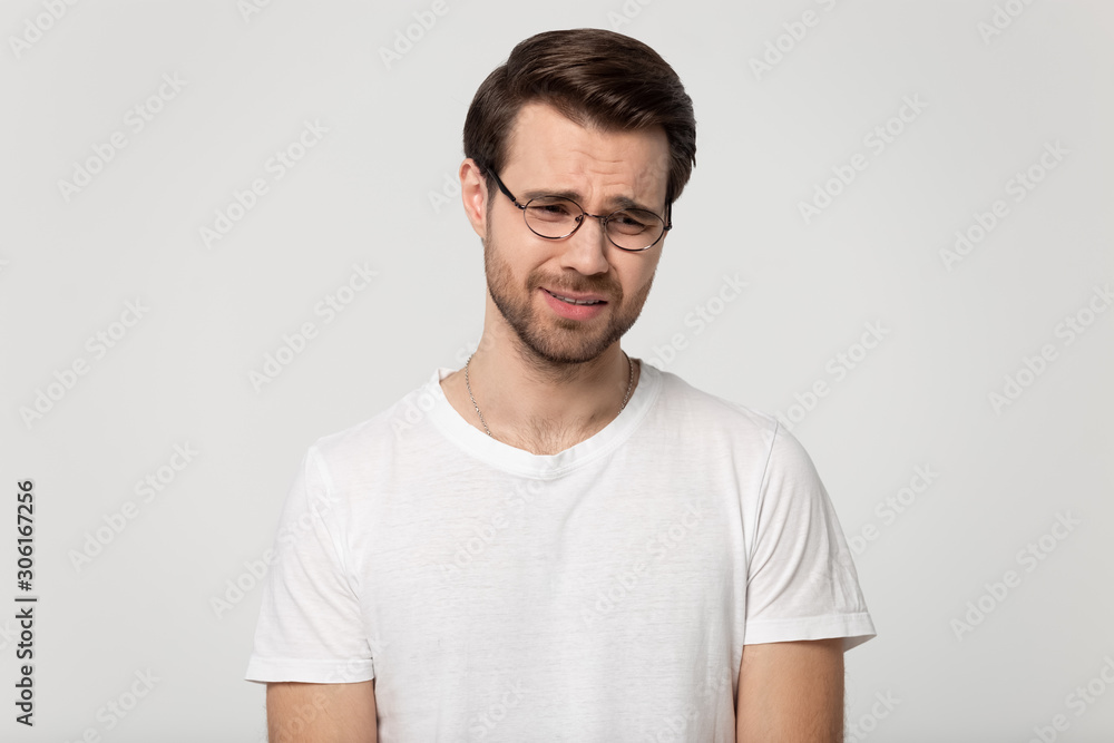 Fototapeta premium Unhappy Caucasian man isolated in studio crying having problems