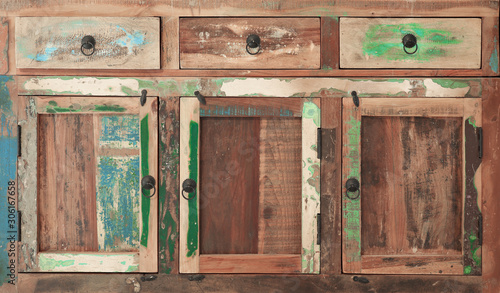 An old wooden multi-colored cupboard as background