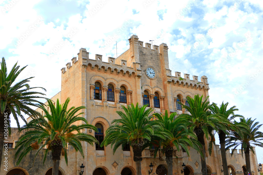 Town hall of Ciutadella de Menorca with palm trees in dront of it