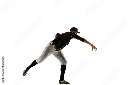 Baseball player, pitcher in a black uniform practicing and training isolated on a white background. Young professional sportsman in action and motion. Healthy lifestyle, sport, movement concept.